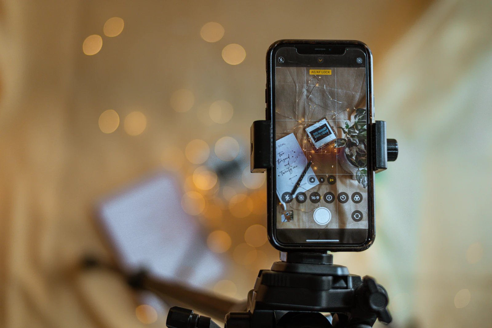 A smartphone on a tripod filming content