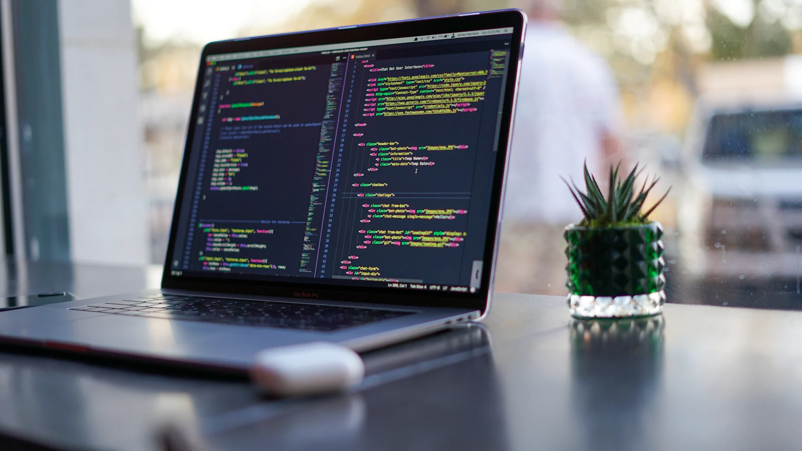 A laptop with code on a bright desk